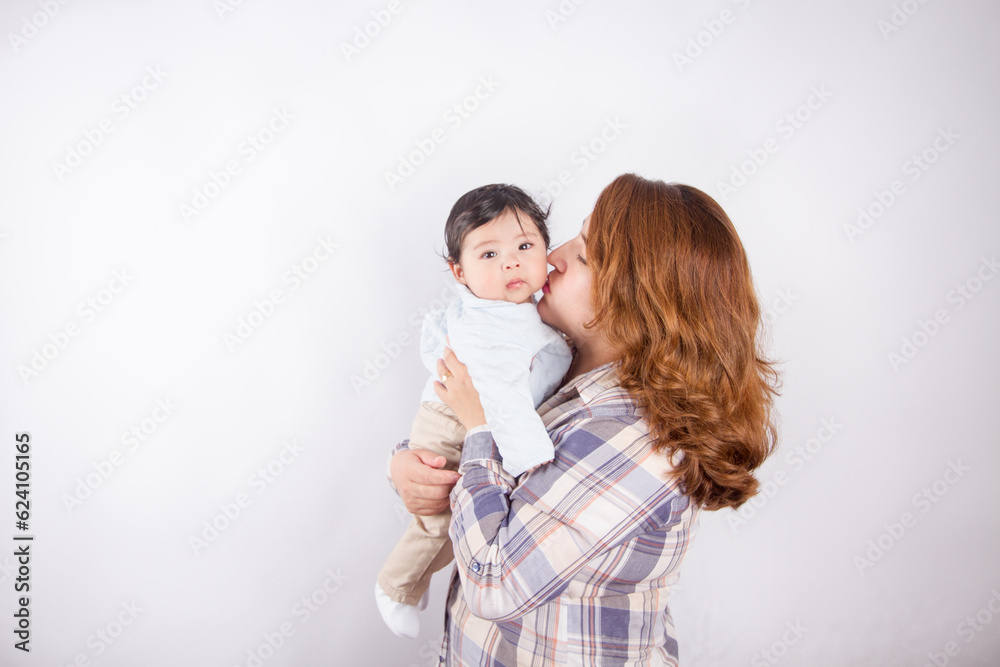 Beautiful photo of mom holding baby on light background in photo studio. Family and baby concept. Beautiful photo of mom holding baby on light background in photo studio. Family and baby concept.