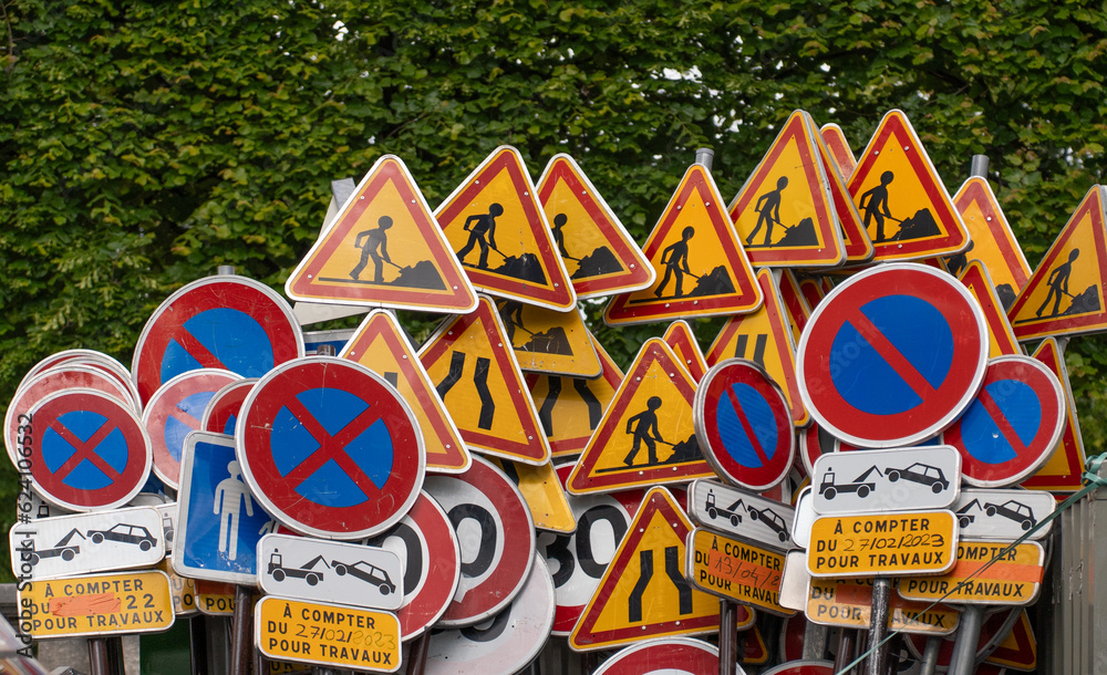 A pile of construction road signs