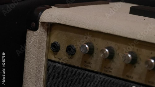 Plugging in cable into the jack of amplifier.