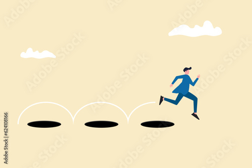 Businessman jump pass many hole to achieve business success. concept of Avoid pitfall, target, and success photo