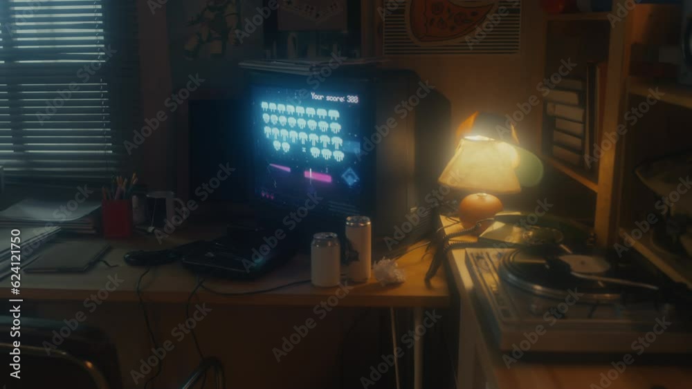 No people shot of retro video game on TV screen, lamp, cans with drinks on table in garage office, 90s aesthetics