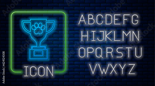 Glowing neon Pet award symbol icon isolated on brick wall background. Medal with dog footprint as pets exhibition winner concept. Neon light alphabet. Vector