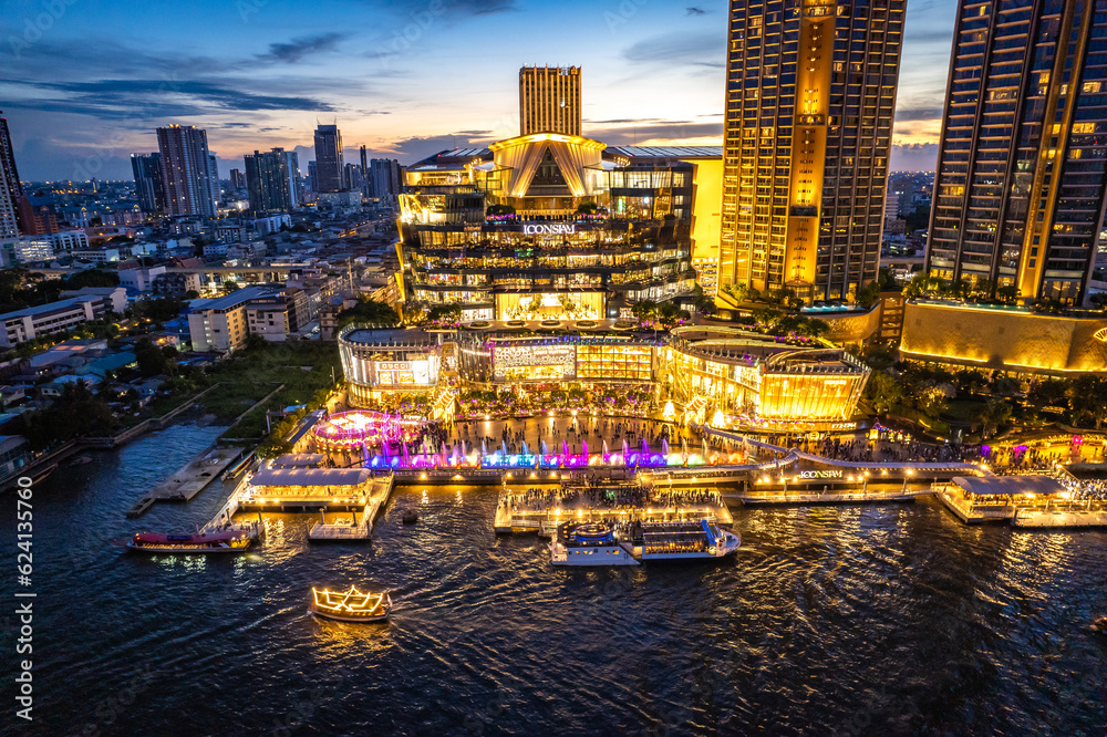 Naklejka premium Aerial view of Icon Siam mall by night on the chao phraya river in khlong san, bangkok, Thailand