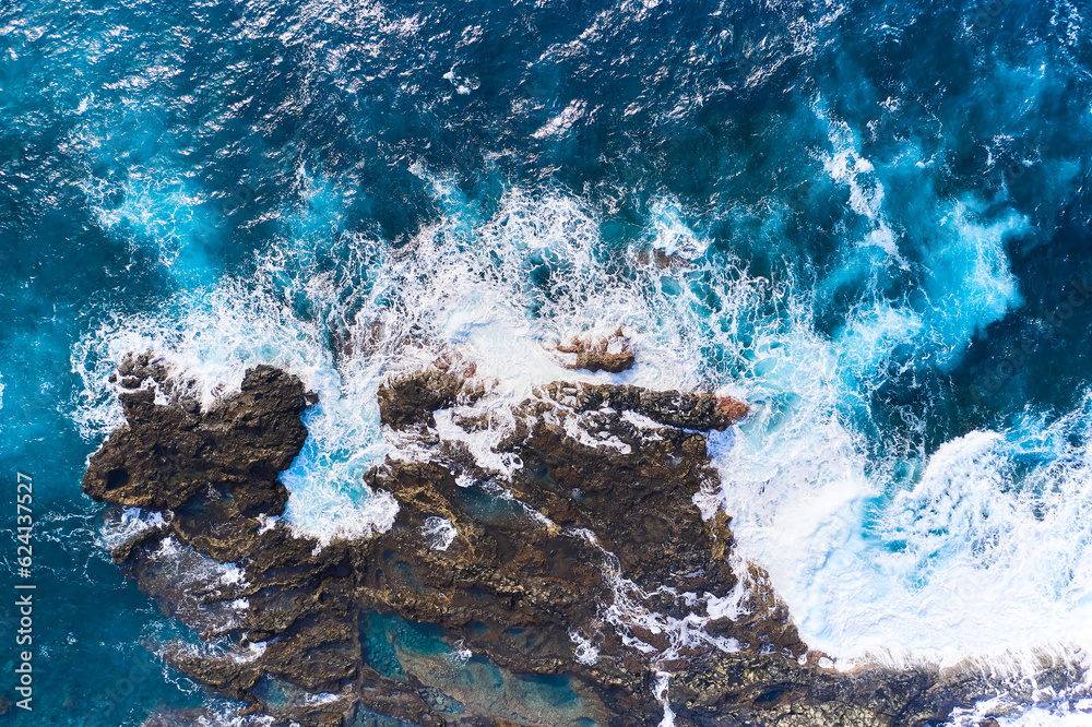 Salty sea water boils near the stones. Powerful waves crash against the rock Salty sea water boils near the stones. Powerful waves crash against the rock