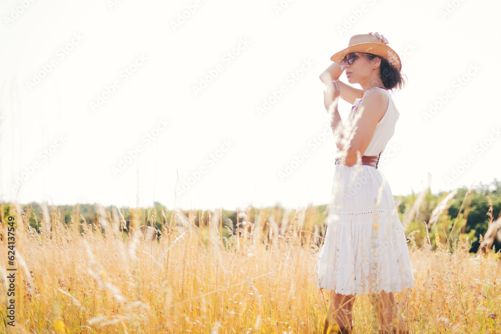 Portrait of woman in golden sunset light in outdoor meadow. Springtime and summer lifestyle. Wellbeing and zen like meditation activity in outdoor. Loving life. Portrait of woman in golden sunset light in outdoor meadow. Springtime and summer lifestyle. Wellbeing and zen like meditation activity in outdoor. Loving life.