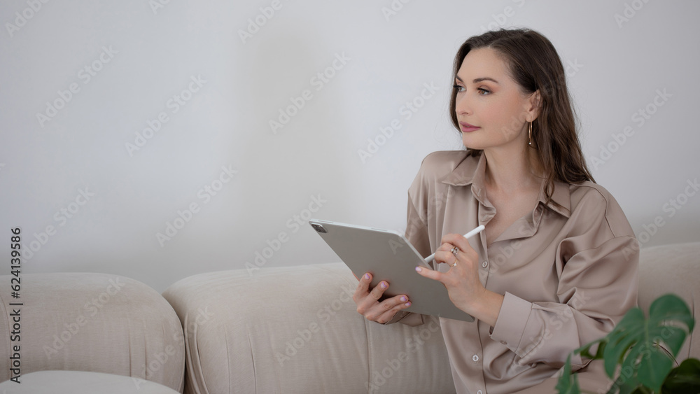 A specialist woman with a tablet in her hands gives consultations, a conversation with a psychologist or a consultation with an interior designer A specialist woman with a tablet in her hands gives consultations, a conversation with a psychologist or a consultation with an interior designer