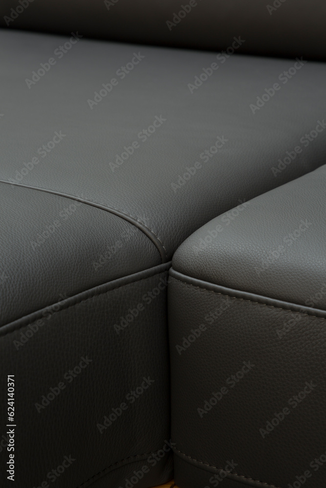 Corner sofa made of leather. Photograph of details in an interesting light