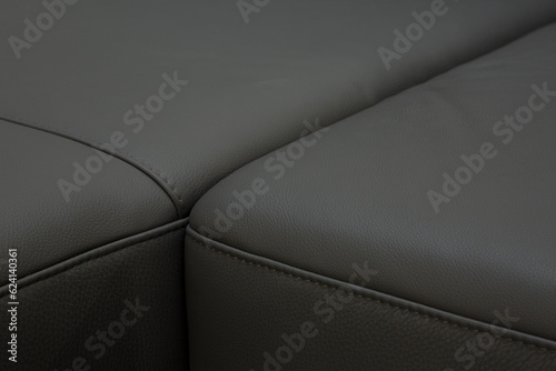 Corner sofa made of leather. Photograph of details in an interesting light