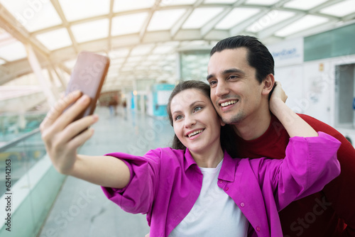 Happy Tourists Spouses Posing Holding Smartphone Making Selfie At Airport
