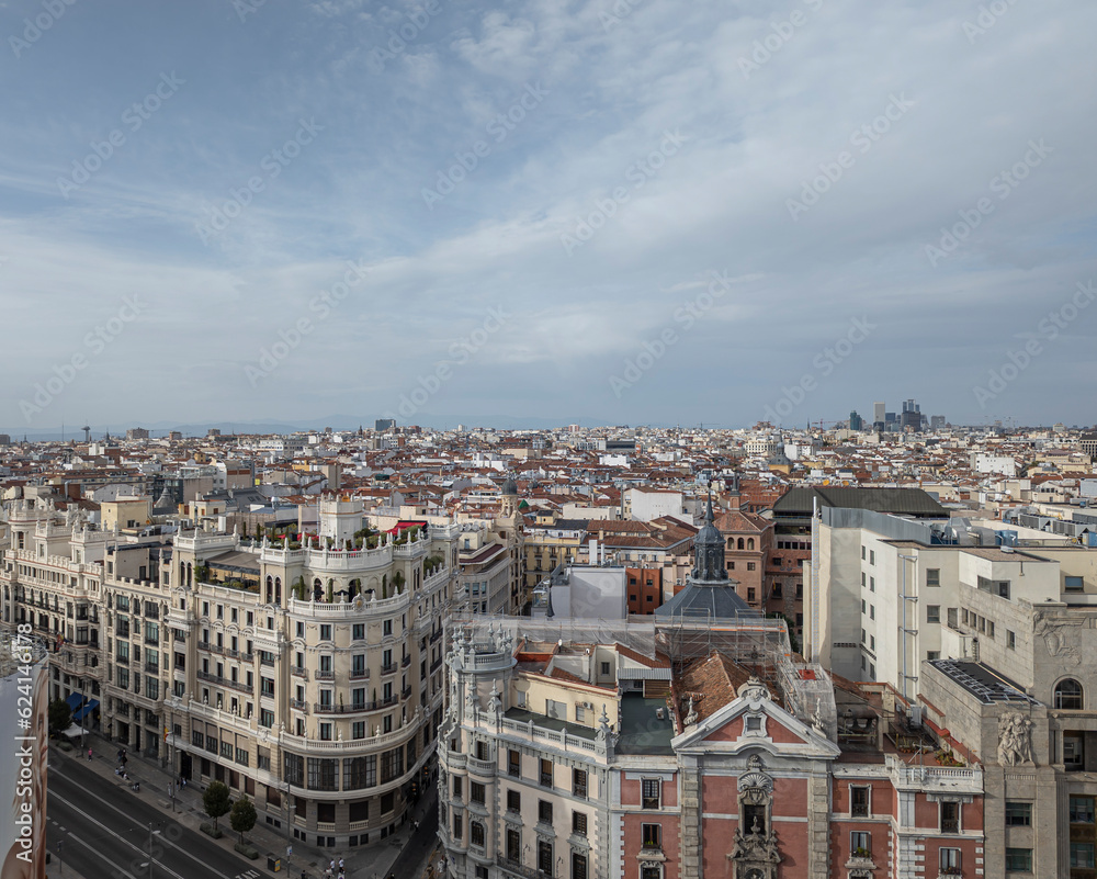 Unforgettable Panoramic Vantage: Glimpsing the Bustling Energy of Madrid's Gran Via from a Spectacular Rooftop Overlook