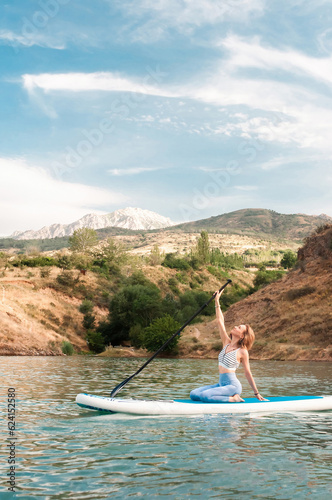 Woman on sup board. Mountain background. Healthy lifestyle © LN