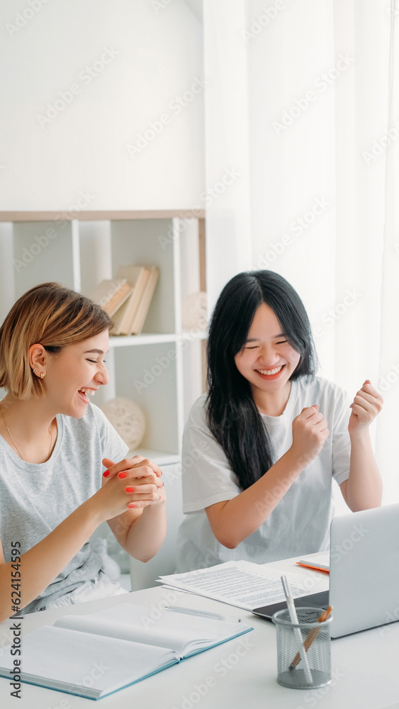 Project success. Work celebration. Two happy excited women employees colleagues satisfied with business goal achievement at workplace desk at office. Project success. Work celebration. Two happy excited women employees colleagues satisfied with business goal achievement at workplace desk at office.