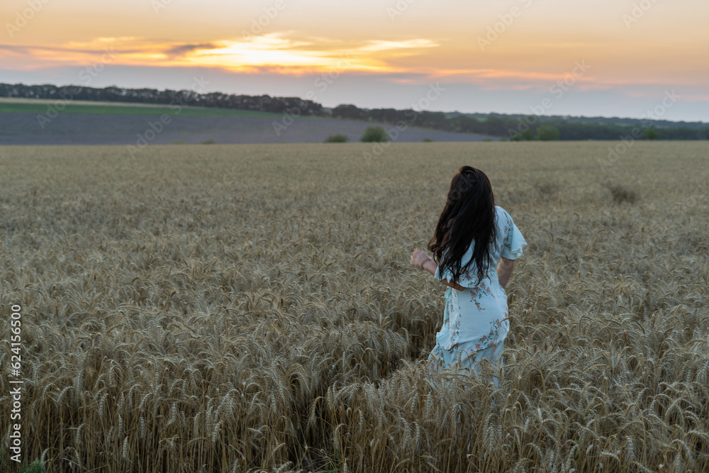 woman in wheat field at sunset woman in wheat field at sunset