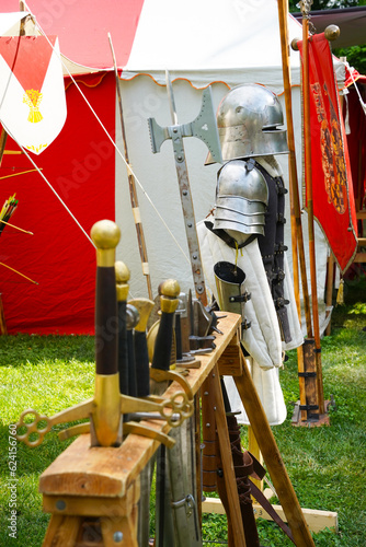 medieval armor and weapons for knight, swords, armor, axe, tent, knight, flag photo