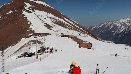 Almaty Kazakhstan 25 March 2023. Medeo Shymbulak Mountain Resort's ski slopee with skiers and snowboarders. Skiers at slopes of ski resort Chimbulak.  photo