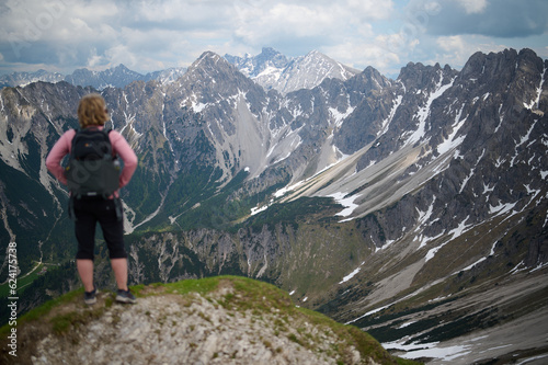 Woman Hiking, Overlooking Austrian Alps from the Top of a Mountain