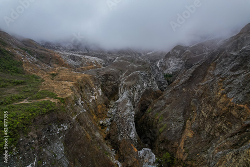 Beautiful nature view of the the Poas Volcano Canon, mountains and trial hick to the tourquoise waters with explorers