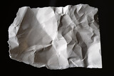 Piece of old paper. Torn white sheet. Wrinkled white material. Paper isolated on black background. Piece of crumpled wallpaper. White paper with folds. Fragment of torn page for design use