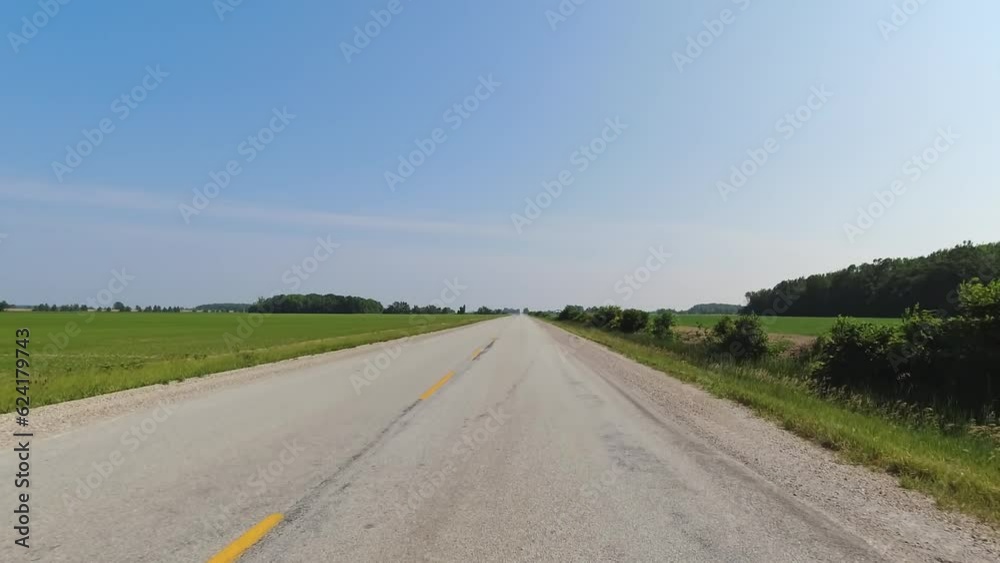 Cinematic POV shot of asphalt country side road Canada. Point of view, front car view. Road ahead driving view during travel driving on the highway. Vehicle car speeding view above the road surface. Cinematic POV shot of asphalt country side road Canada. Point of view, front car view. Road ahead driving view during travel driving on the highway. Vehicle car speeding view above the road surface.