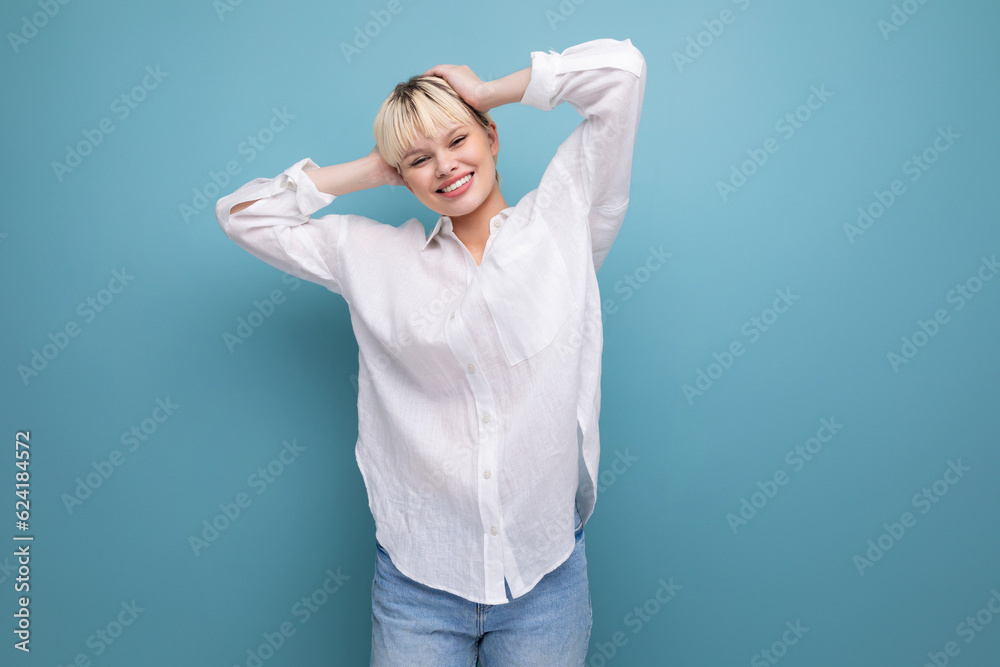 Fototapeta premium young pretty caucasian blond career woman in white blouse isolated on blue background with copy space