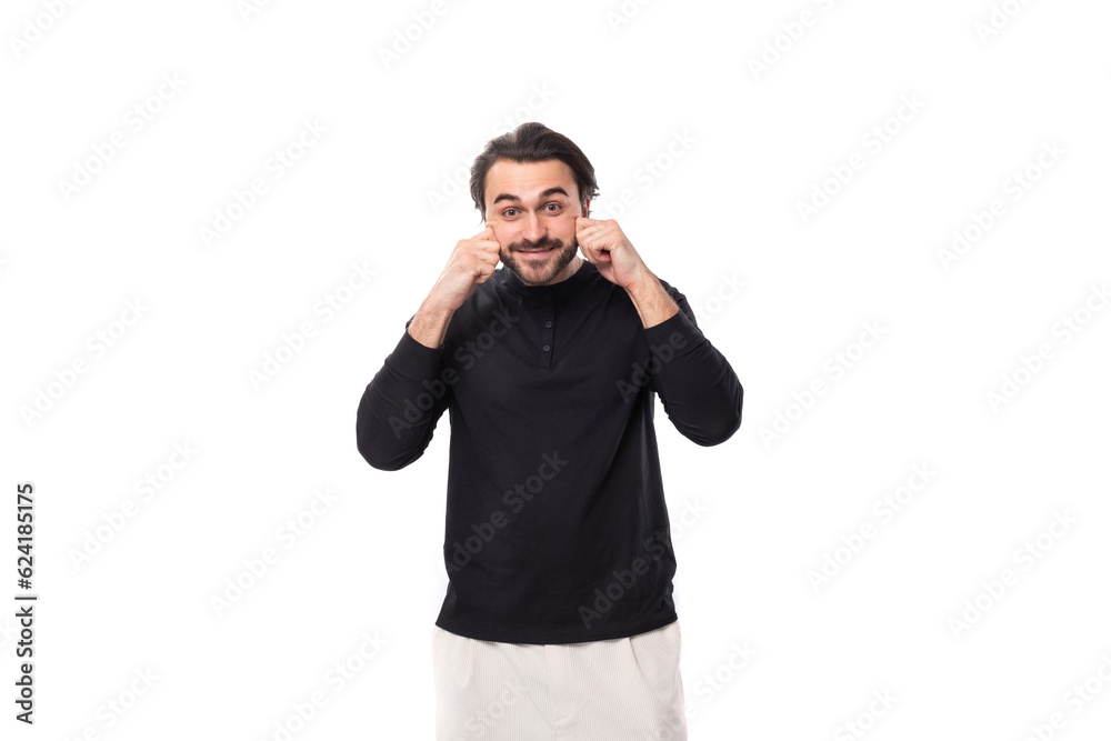 young handsome caucasian brunette man with a beard in an informal style put on a smile young handsome caucasian brunette man with a beard in an informal style put on a smile