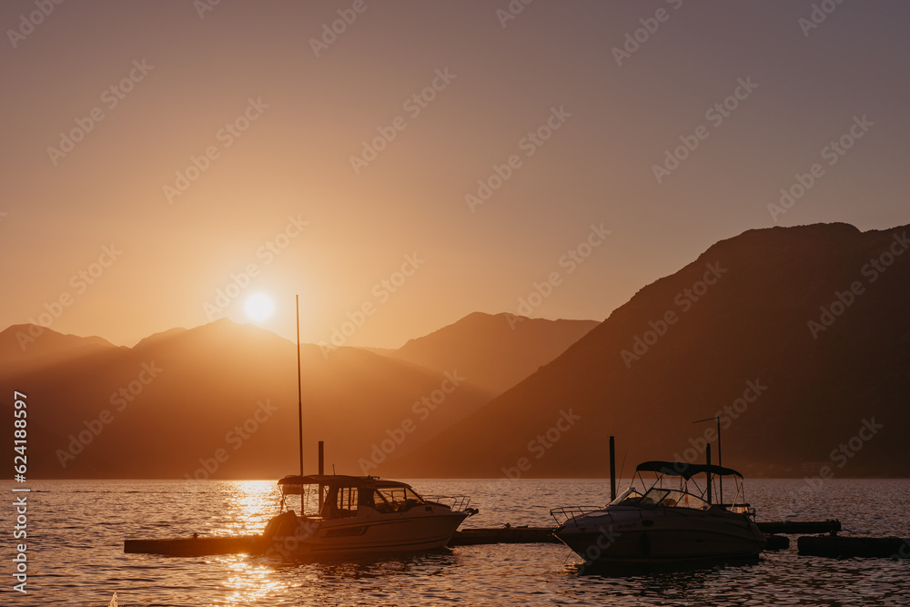 Silhouette of sailing yachts in the sea on beautiful sunset backgroung