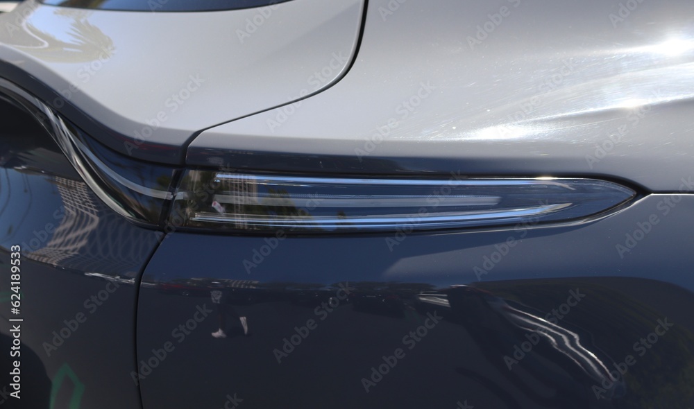 Closeup of Luxury SUV tail light LED. Beautiful new luxury suv in the sunlight wallpaper image for advertising or website style.