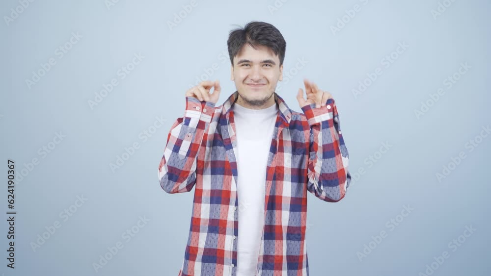 The man making cute gestures for the camera.