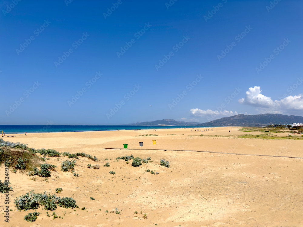 extensive wide sandy beach and dunes in Tarifa at a beautiful summer day and blue sky, Llaya de los Lances, Playa Santa Catalina, Andalusia, province of Cádiz, Spain