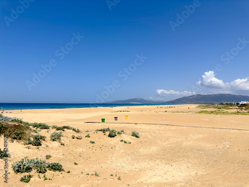 extensive wide sandy beach and dunes in Tarifa at a beautiful summer day and blue sky, Llaya de los Lances, Playa Santa Catalina, Andalusia, province of Cádiz, Spain