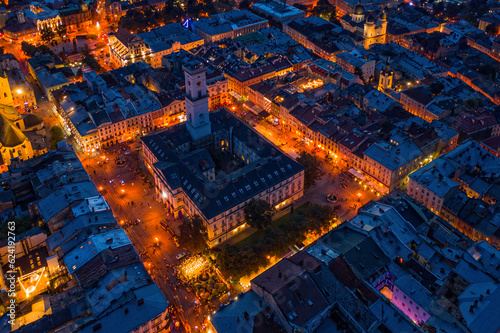 Rooftops of the old town in Lviv in Ukraine during the evening. The magical atmosphere of the European city. Landmark, the city hall and the main square. Drone photo.