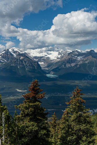 Iconic Lake Louise seen from a distance near the gondola with stunning mountain views surrounding the turquoise nature  national park area. 