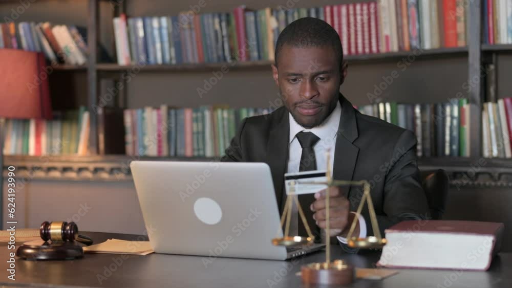 African American Lawyer Doing Online Shopping on Laptop African American Lawyer Doing Online Shopping on Laptop