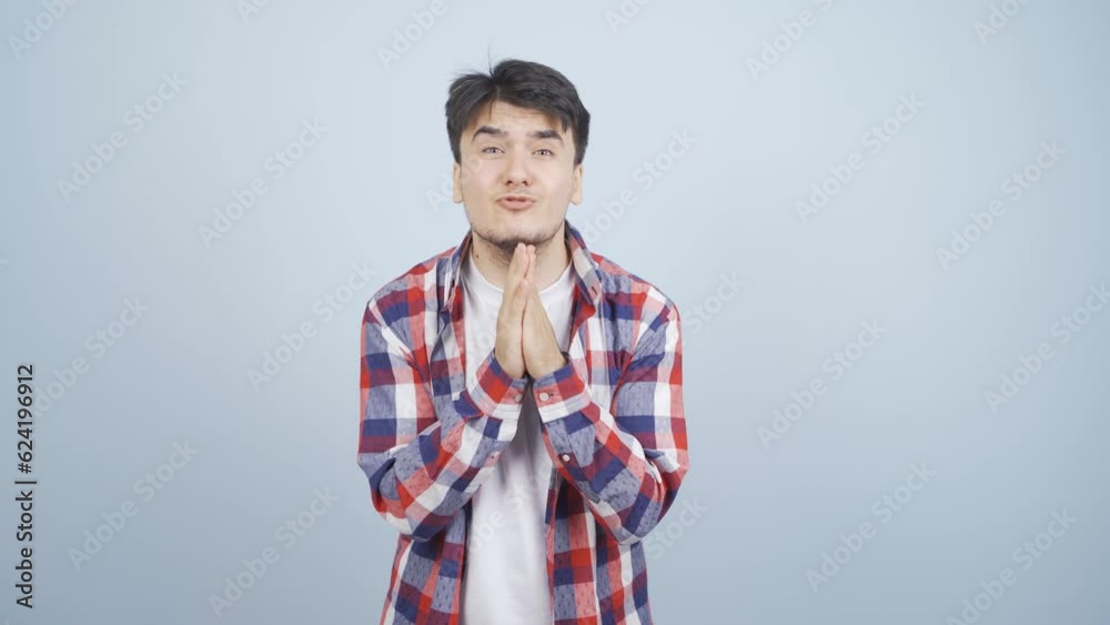 Man apologizing looking at camera.