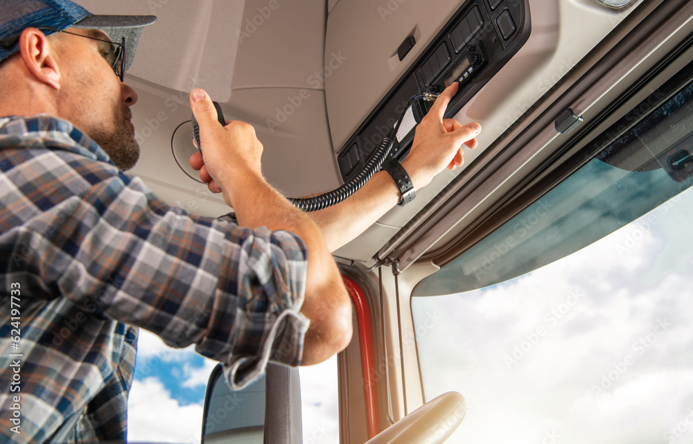 Professional Truck Driver Using CB Radio To Communicate Stock Photo