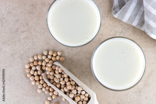 Chickpea milk with chickpeas on a beige background. Top view. 