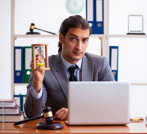 Young male lawyer sitting in the office