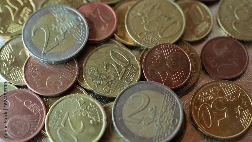 Euro cents coins close-up in flickering multicolored light.Inflation of money in the EU countries.Euro exchange rate in the European Union.Money background. EU currency.Money and finance. 4k footage Euro cents coins close-up in flickering multicolored light.Inflation of money in the EU countries.Euro exchange rate in the European Union.Money background. EU currency.Money and finance. 4k footage