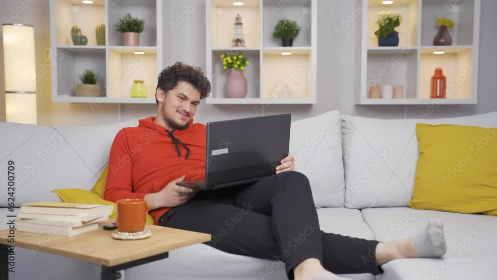 Man watching movie on laptop with happy expression. Man watching movie on laptop with happy expression.