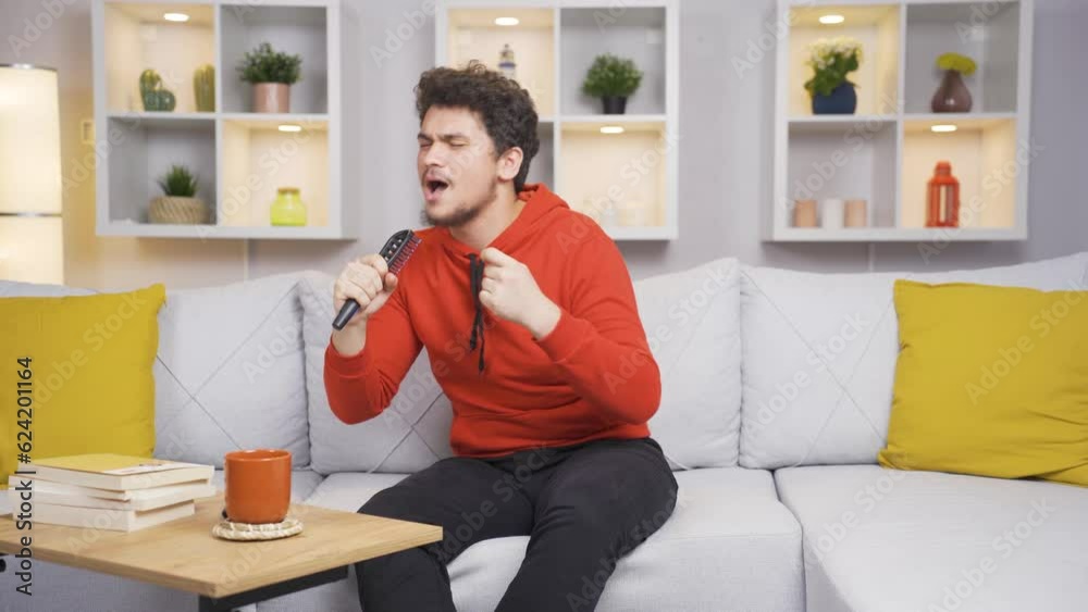 The man sings to himself at home, he is relaxed and happy. The man sings to himself at home, he is relaxed and happy.