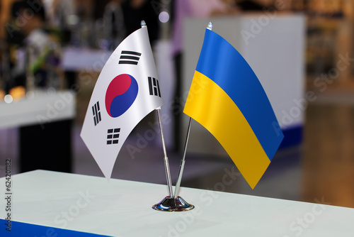 Flags of Ukraine and South Korea together at some event or fair. Flags of the two countries as a symbol of cooperation between the two states. Joint business of Republic of Korea and Ukraine