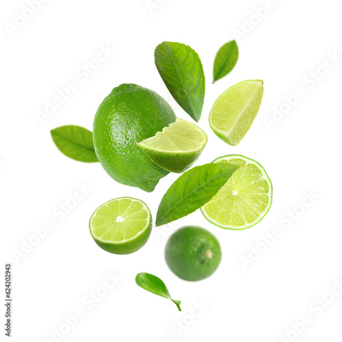 Fresh lime fruits and green leaves falling on white background