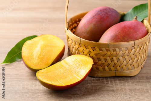 Mango fruit (Palmer mango) in basket on wooden background, Tropical fruit