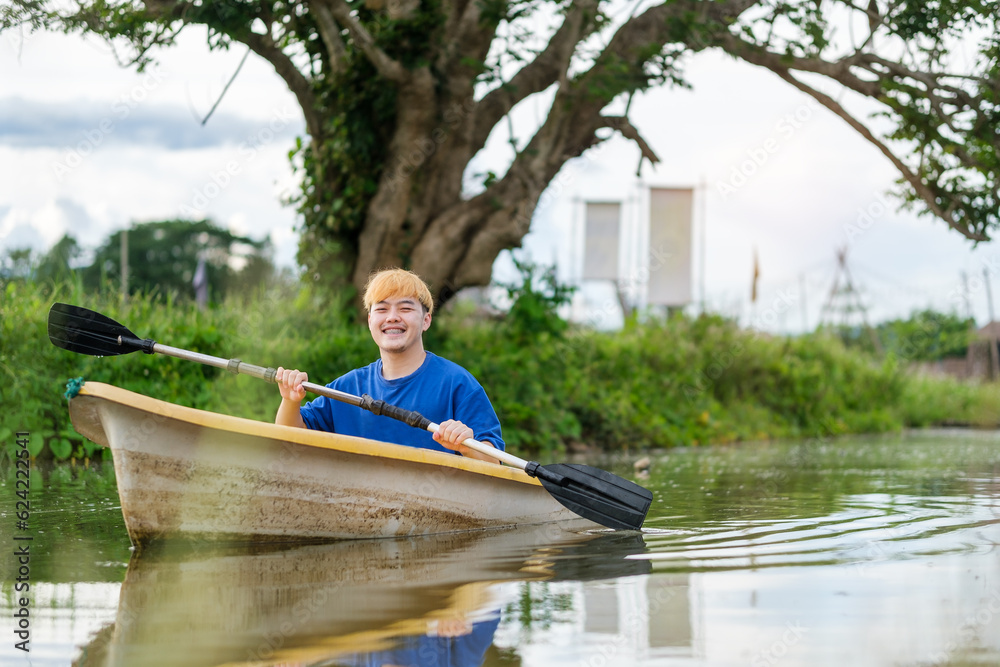 Smiling man tourists rowing boat on the river.ravel, vacation holiday and outdoor activity. Smiling man tourists rowing boat on the river.ravel, vacation holiday and outdoor activity.