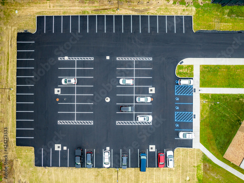 Aerial view of a partially filled new asphalt US parking lot. photo