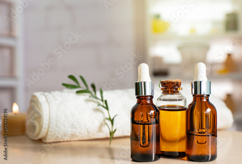 Bottles on the background of the spa room. Skin care serum or natural cosmetics with essential oil. face and body beauty concept. Spa concept. Place for text. photo