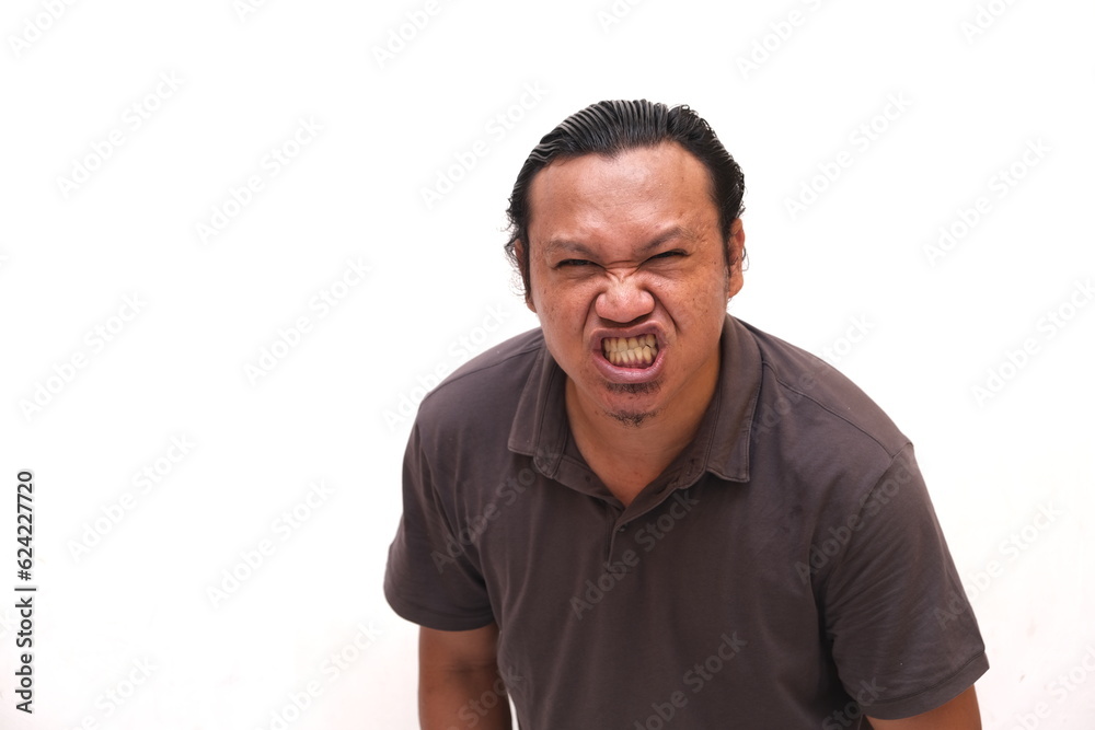 angry expression of asian man isolated on red background angry expression of asian man isolated on red background