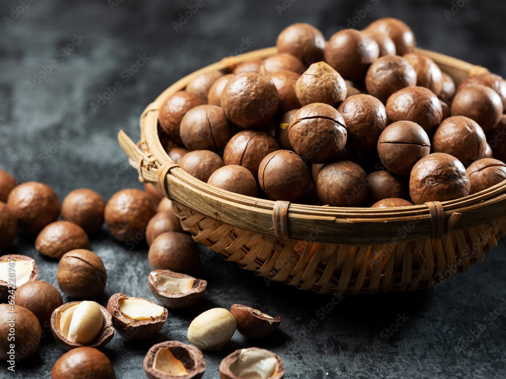 Roasted macadamia nuts on a dark background Roasted macadamia nuts on a dark background