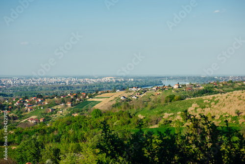 Panoramic view of the city of Novi Sad in Serbia from the top of Mount Fruska. View of the forest, fields, suburbs and city in spring sunny day