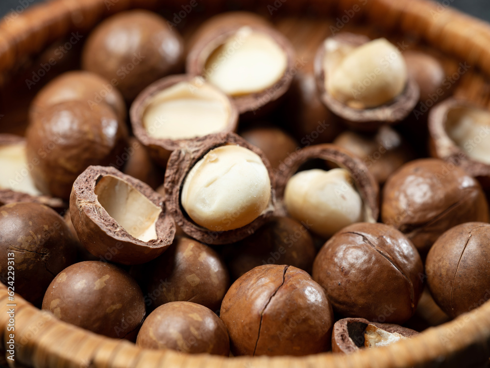 Roasted macadamia nuts on wooden background Roasted macadamia nuts on wooden background
